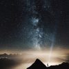 Man Shines torch from mountain print