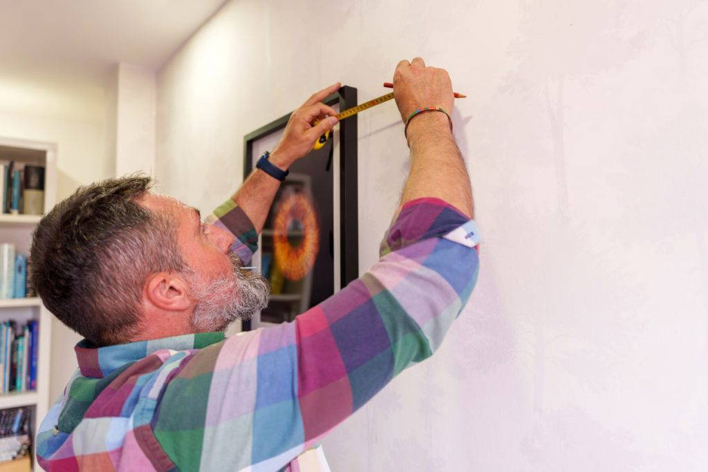 using measuring tape to hang framed picture